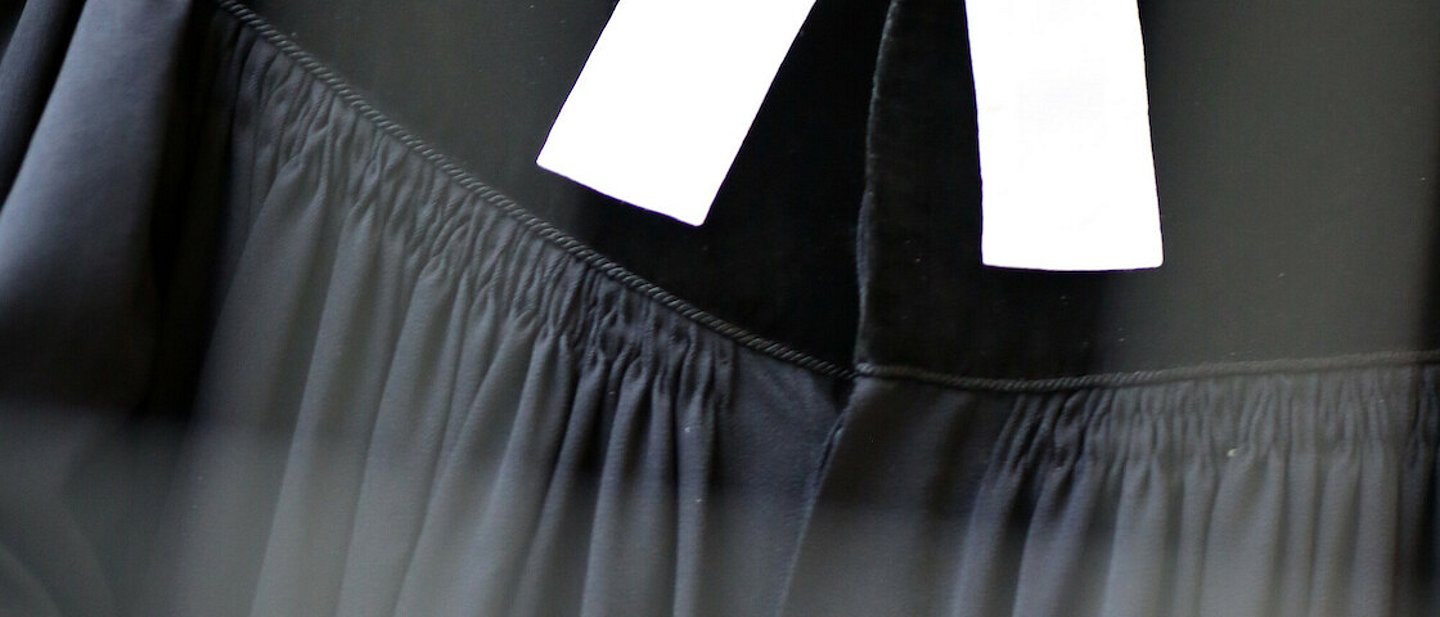 Schwarzer Pfarrtalar mit weißem Beffchen