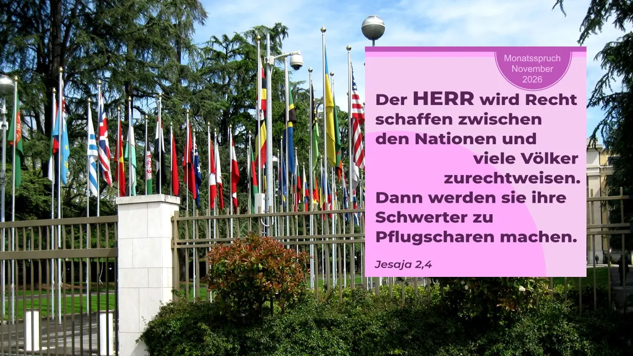 zu sehen sind Fahnen vieler Länder und als Grafik der Monatsspruch von November 2026 