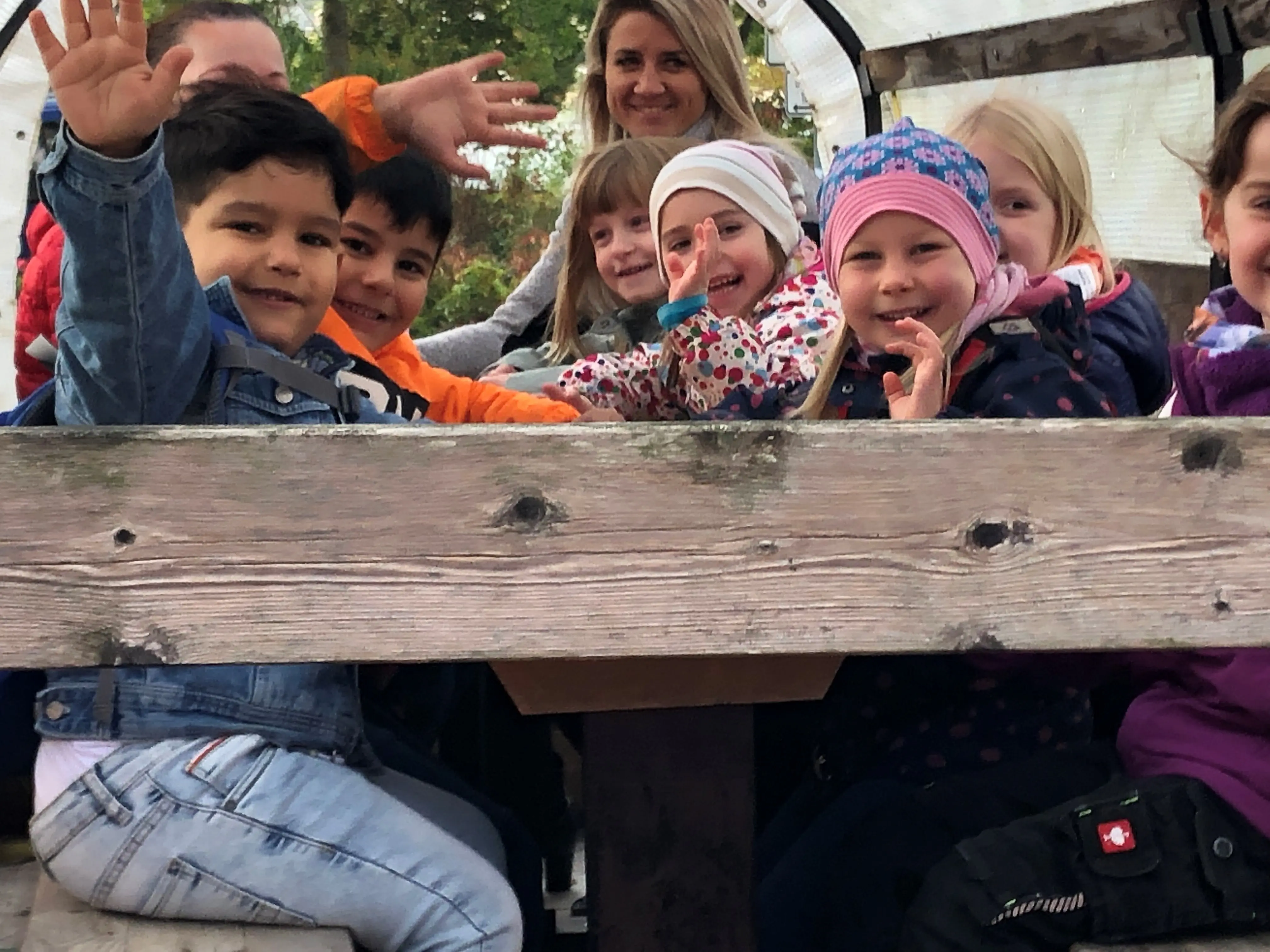 Die Kinder der KiTa fahren mit einem Planwagen.