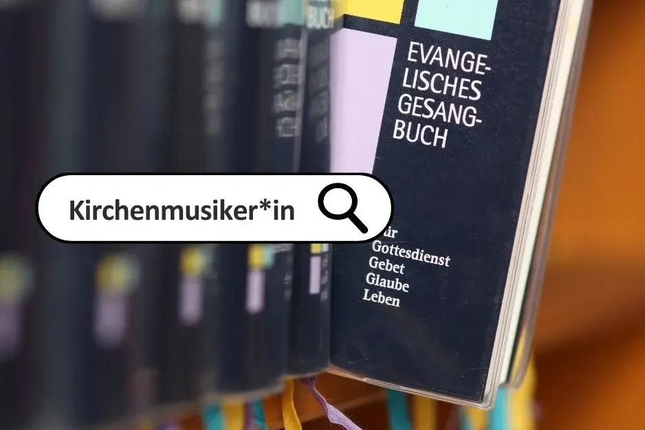 Eine Reihe Kirchengesangbücher in einer Kirchenbank, eines steht ein bisschen heraus, so dass man den Titel lesen kann